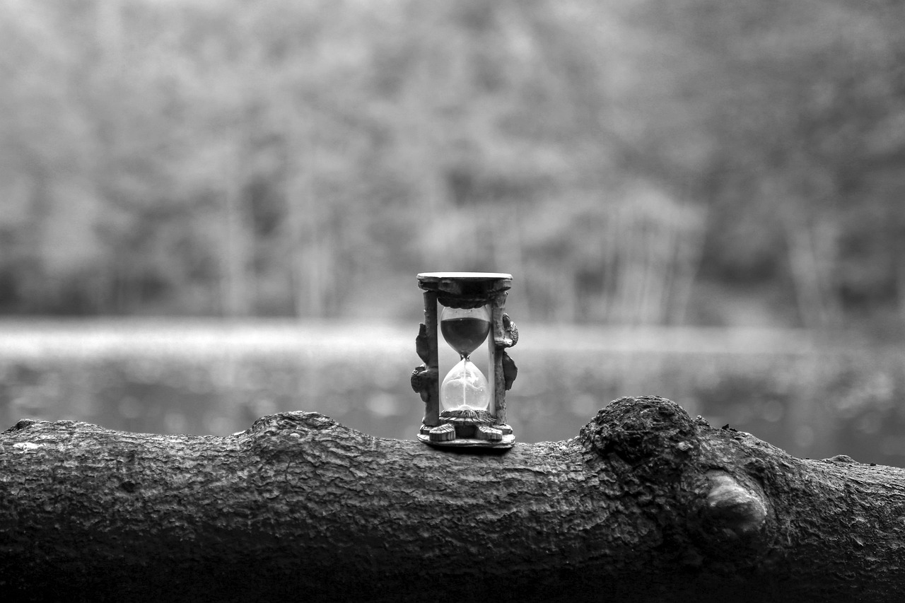 Black and white hourglass representing time, patience, and quiet testing